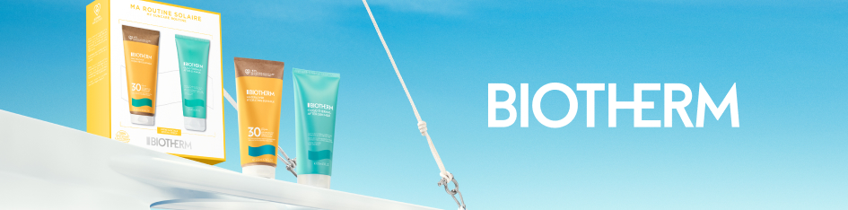 Werbung für Biotherm After-Sun-Set. Zwei Tuben mit Sonnenschutzprodukten stehen neben einer gelben Produktverpackung mit der Aufschrift 'Ma Routine Solaire'. Der Hintergrund zeigt strahlend blauen Himmel und Teile eines weißen Bootes mit Segelseil. Rechts ist das Biotherm-Logo zu sehen.