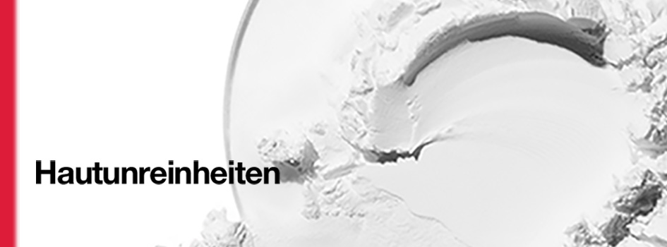 Weiße, cremige Textur in Nahaufnahme mit dem Text 'Hautunreinheiten' und einem roten Streifen am linken Rand.