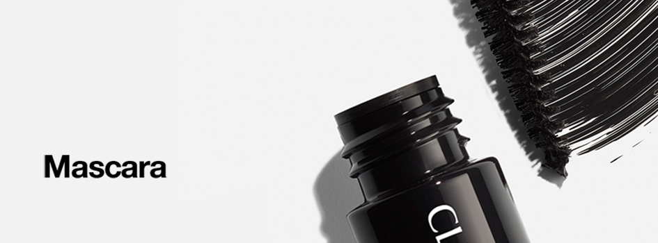 Schwarze geöffnete Mascara mit sichtbarem Bürstenstrich auf hellem Hintergrund. Links im Bild steht der Text 'Mascara'.