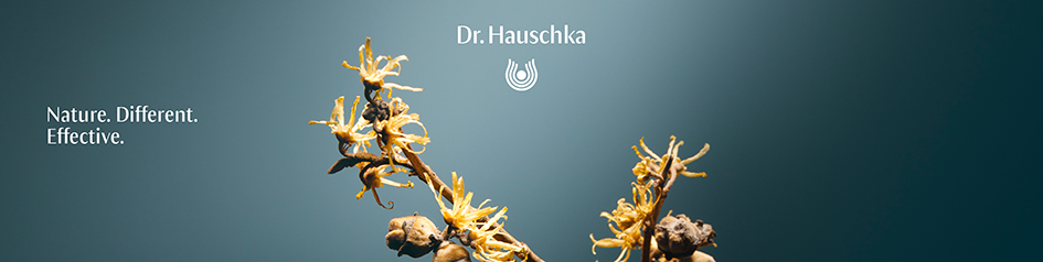 Werbebild von Dr. Hauschka: Zwei gelb blühende Zweige der Zaubernuss (Hamamelis) vor blauem Hintergrund, darüber das Dr. Hauschka-Logo. Links steht der Text „Nature. Different. Effective.“ — das Motiv betont die natürliche und wirksame Pflanzenkosmetik.