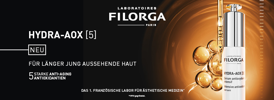 Werbeanzeige für das Filorga HYDRA-AOX [5] Serum. Links steht: 'Neu – Für länger jung aussehende Haut – 5 starke Anti-Aging-Antioxidantien'. Rechts ist das Produkt vor goldbraunem Hintergrund mit leuchtenden Ölperlen und Pipette zu sehen.