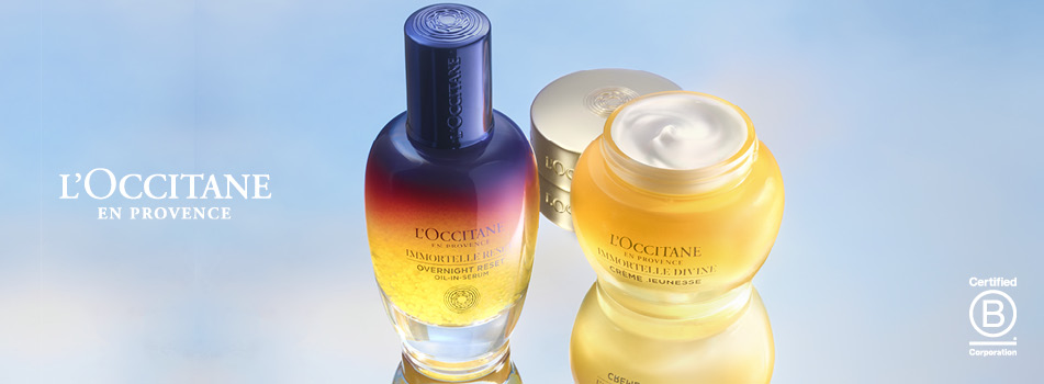 L'OCCITANE Gesichtscreme und Serum in eleganten gold-blauen Gläsern mit Spiegelreflexion.