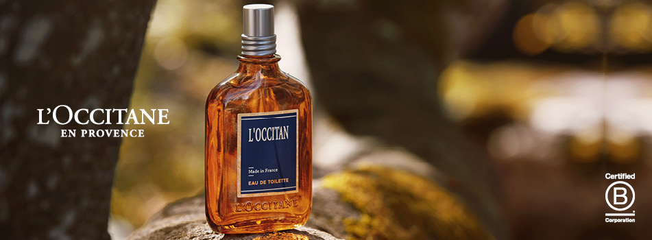 L'OCCITANE Herrenparfum in brauner Glasflasche mit natürlicher Stein-Kulisse.